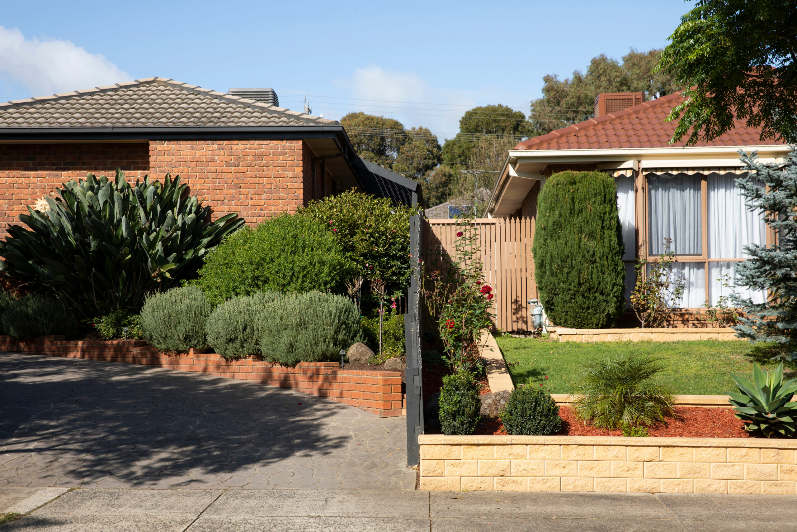 Fence line between two neighboring properties in a suburban setting