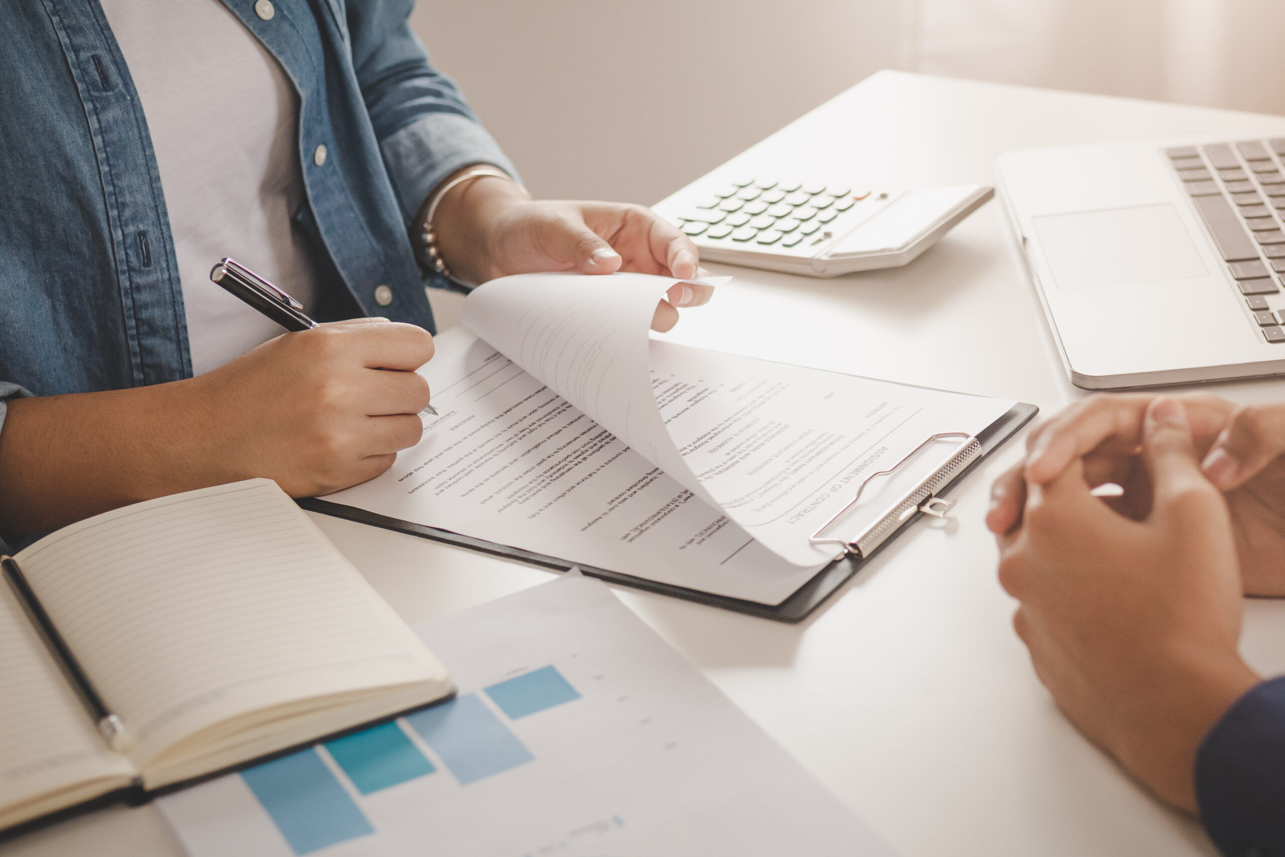 Tenant signing a commercial lease agreement with a landlord